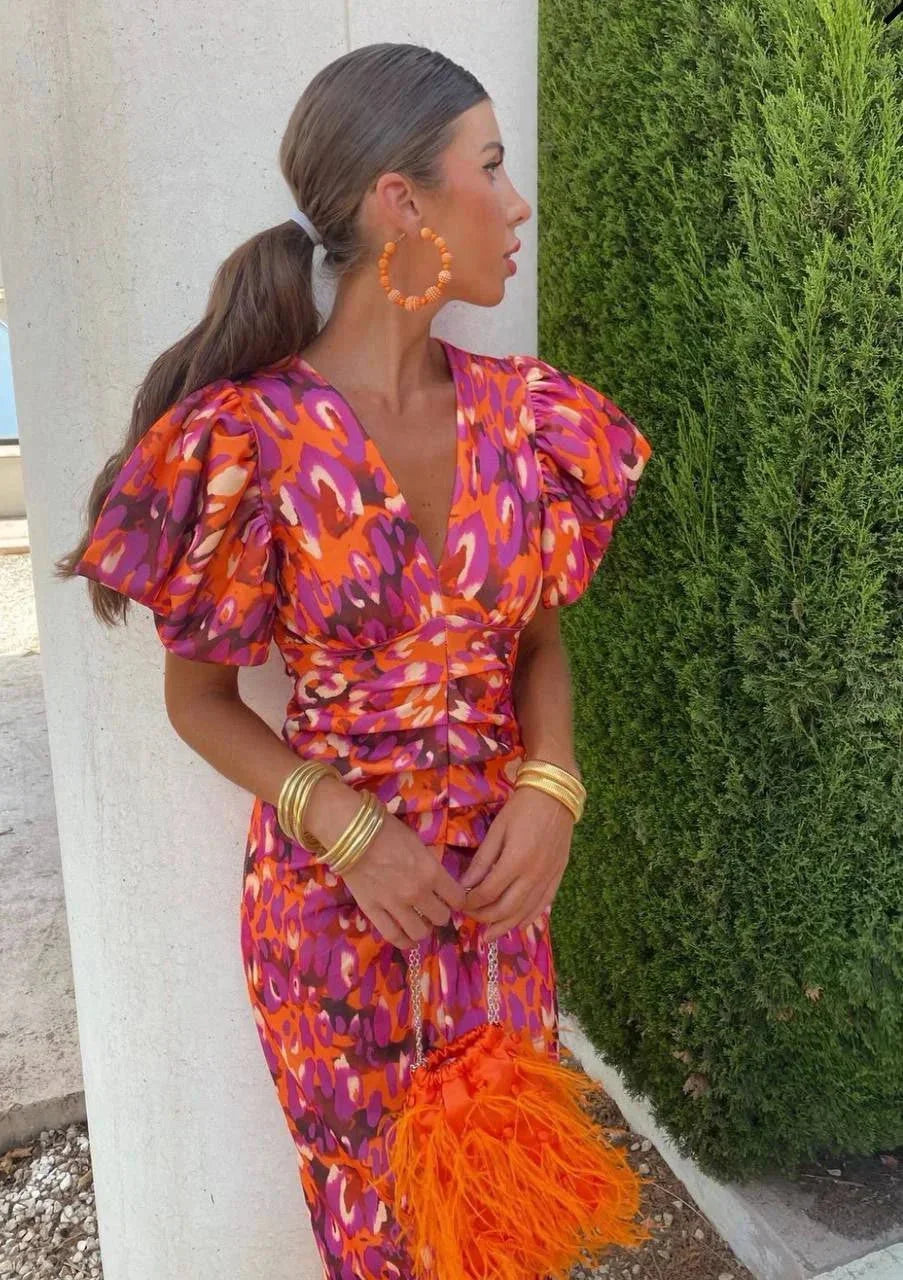 A stylish and comfortable women's midi dress with a v-neck wrap and puff sleeves, ideal for casual or formal occasions.