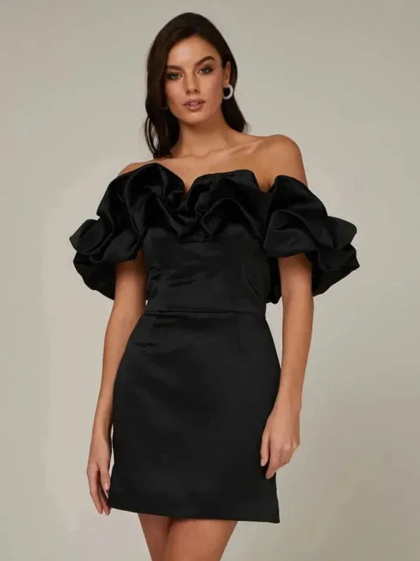 Black off-shoulder mini dress with ruffles, showcasing a fitted silhouette and flattering design for an effortlessly chic…