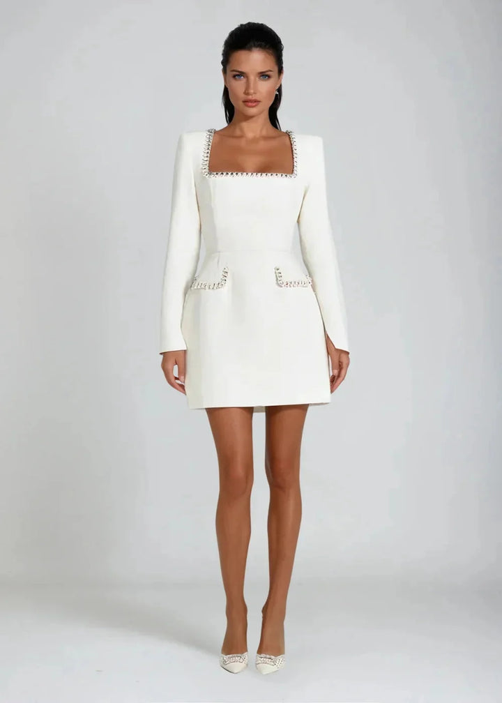 White mini dress with square neckline and bead embellishments. Made with high-quality fabric, perfect for a sophisticated…