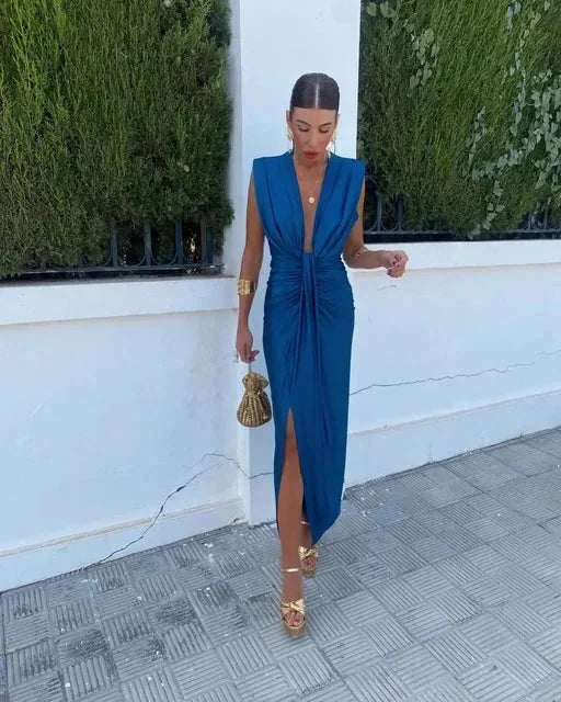Navy blue draped maxi dress with intricate lace detail; perfect for evening events.