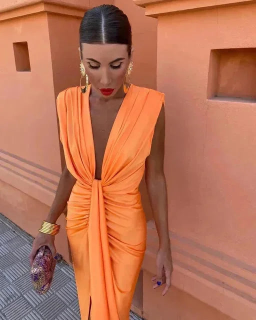 Orange draped in an evening-maxi dress. Flowing fabric with a pleated design perfect for elegant occasions.