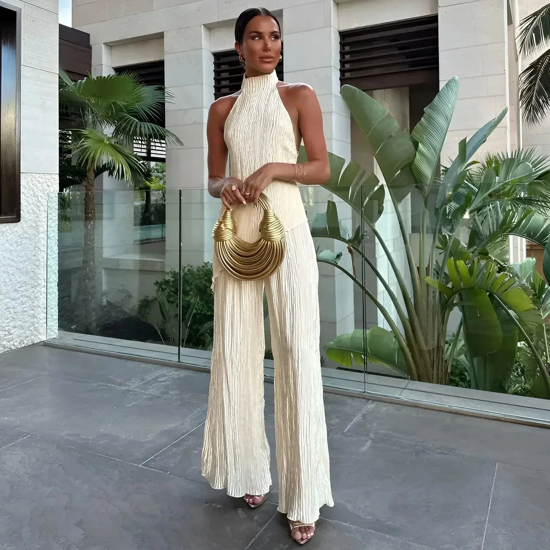 White textured halter jumpsuit for women. Features a halter neckline and unique texture. Perfect for a chic and stylish look.