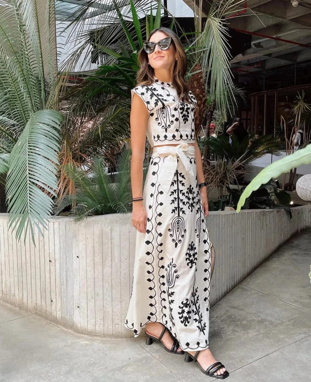 White sleeveless set for women with intricate embroidery detailing. Made of soft, breathable fabric for a stylish and…