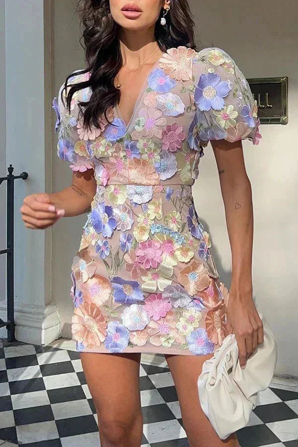 Women's sheer dress with floral appliqué in soft chiffon material. Delicate floral design adds a touch of elegance to the…