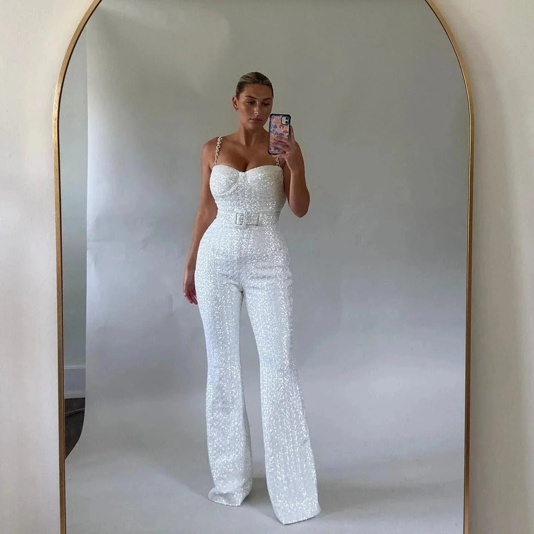 Strapless white jumpsuit with sparkly details and slimming belt, perfect for formal occasions or special events.