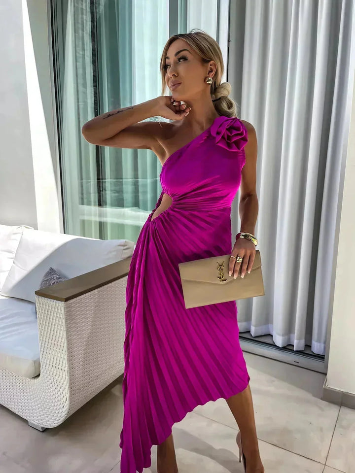 One-shoulder pleated dress in dark blue, flowy fabric, knee-length, ideal for an evening out or special occasion wear.