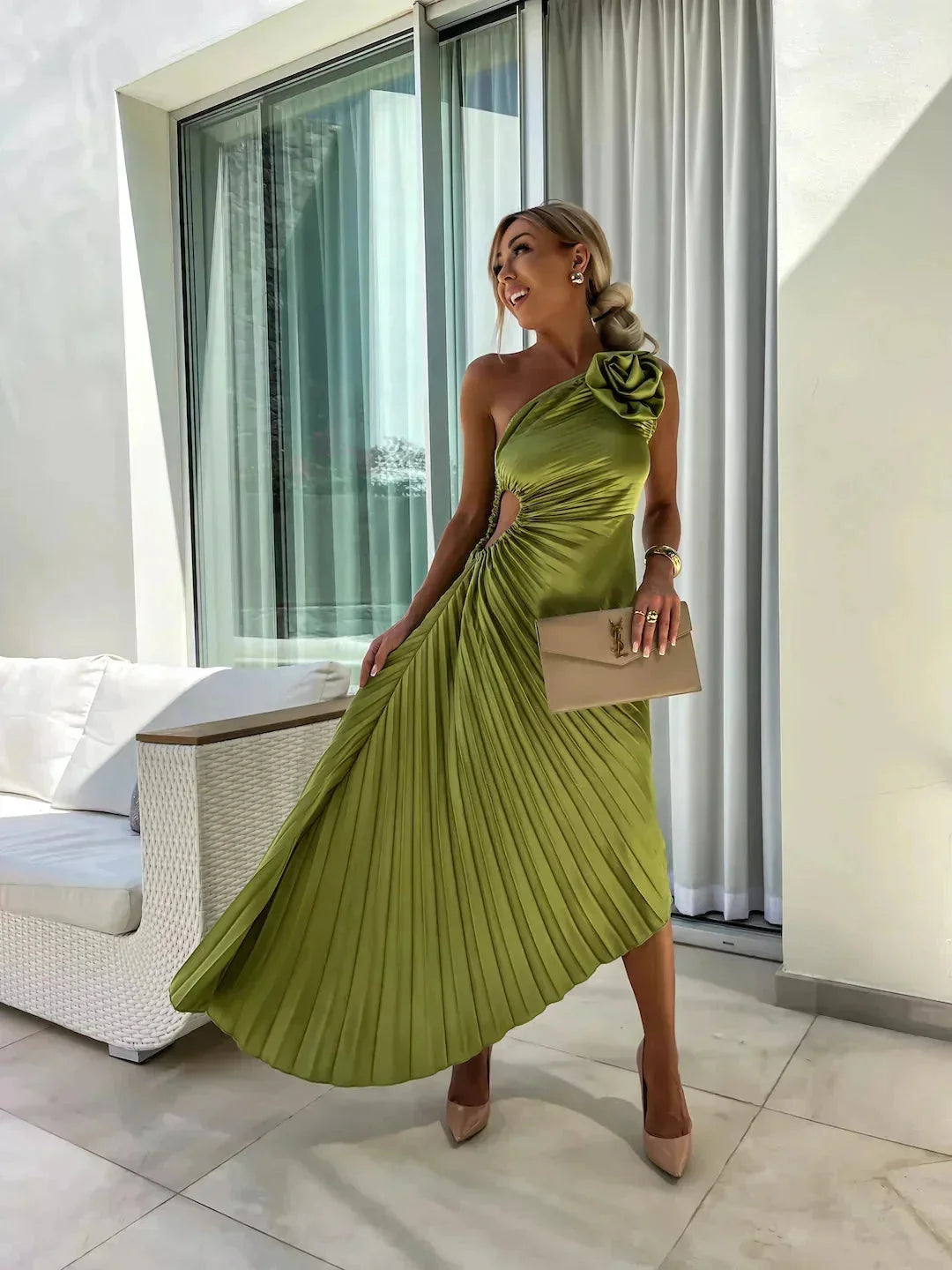 One-shoulder pleated dress in vibrant teal, showcasing elegant draping and a unique asymmetrical design for the modern,…