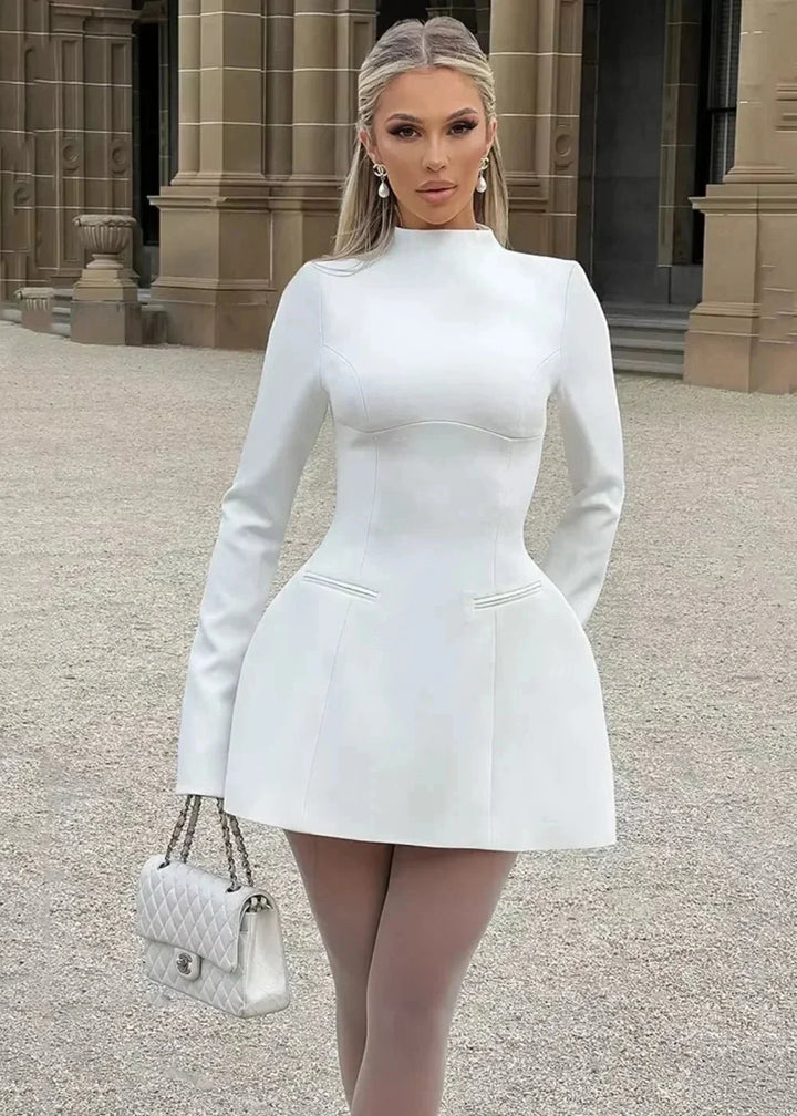 White flared mini dress, chic and elegant design with intricate back detail, perfect for any occasion and crafted from…