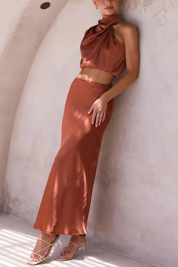 "Two-piece satin halter top and skirt set for women, featuring a sleek and elegant design perfect for special occasions or…